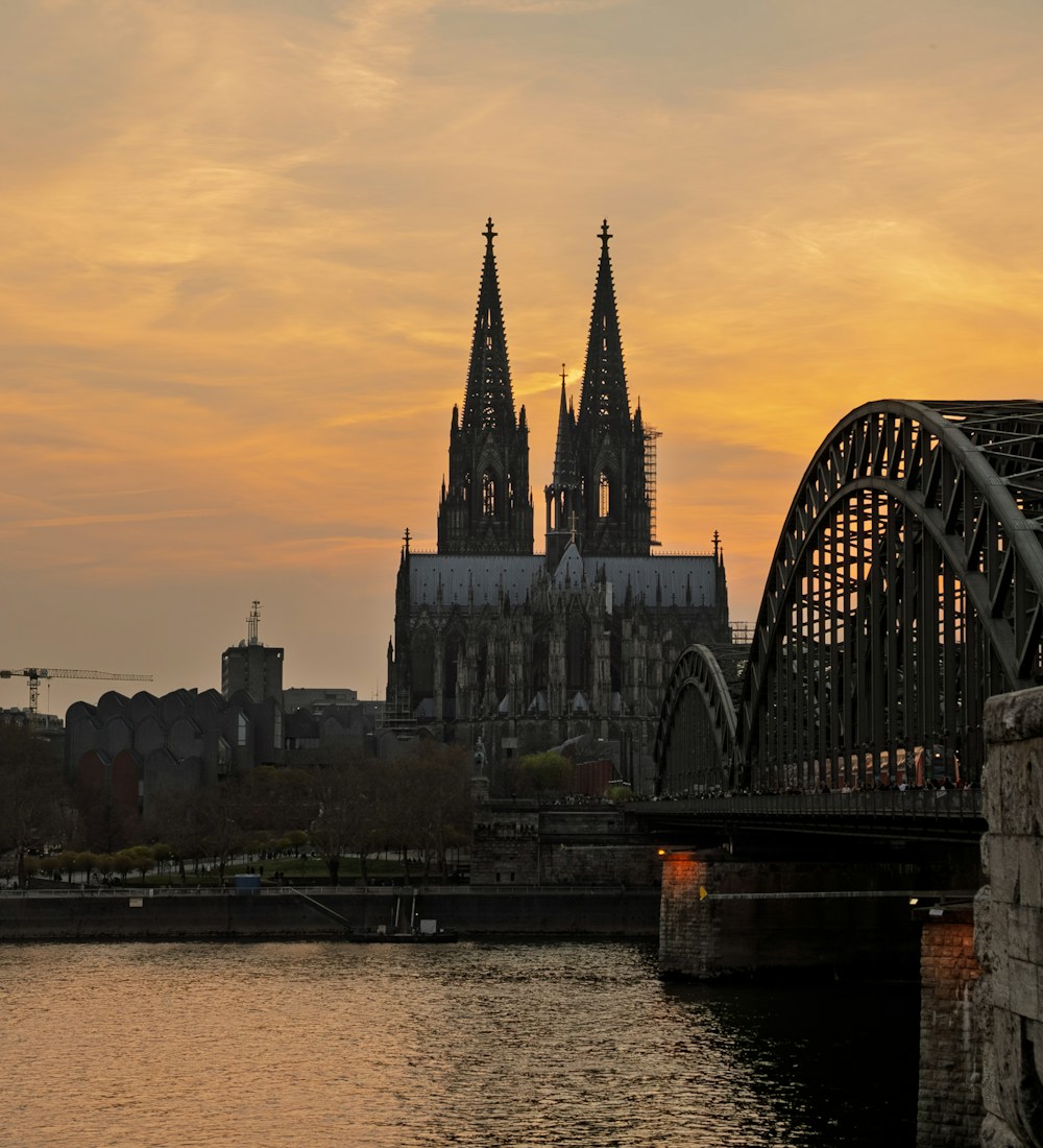 Cologne cathedral and Hohenzollern bridge over the Rhine at sunset